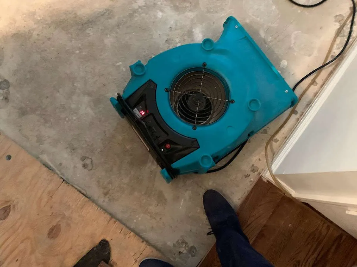 Air mover drying subfloor during Commercial Water Damage Restoration in Lochbuie